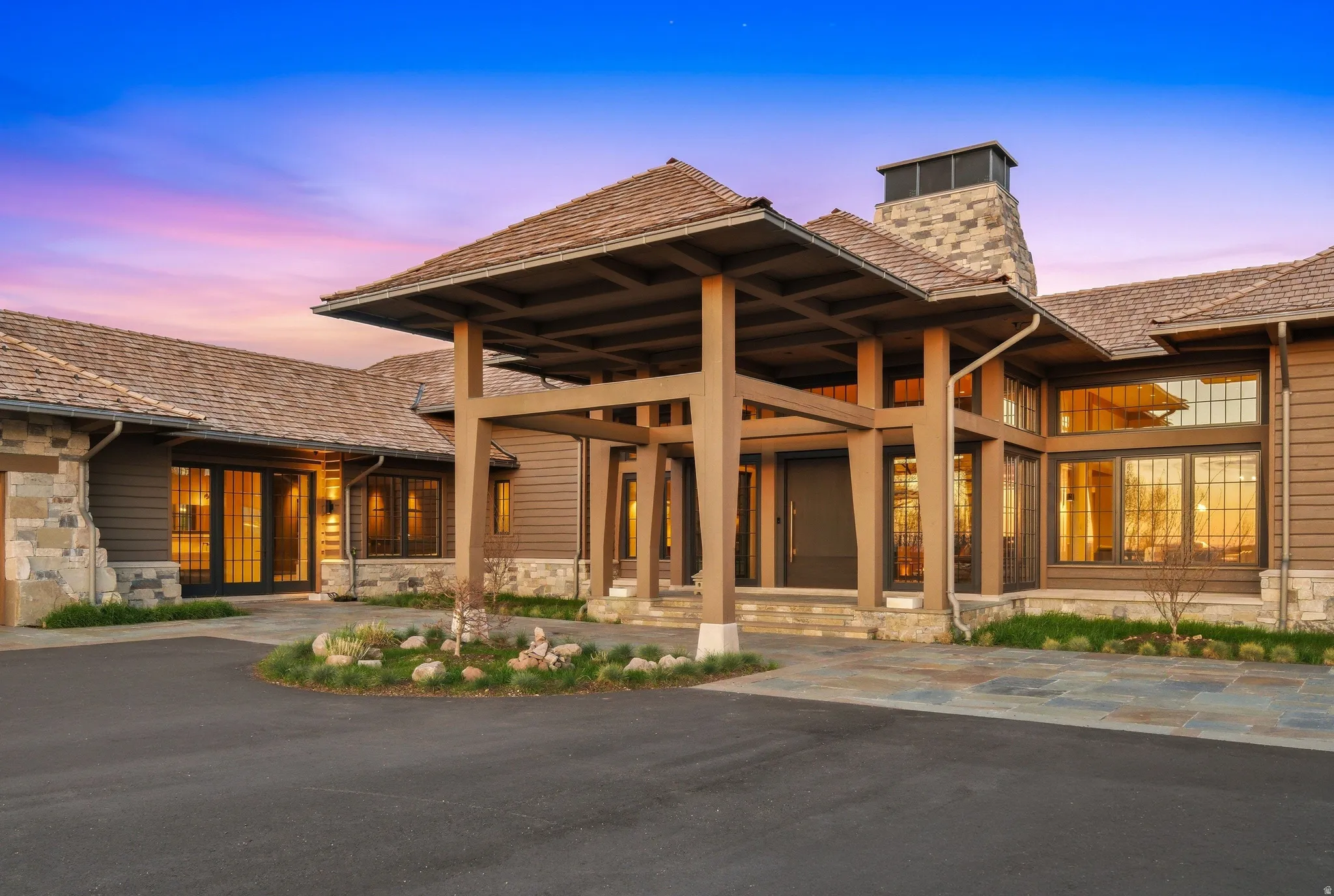Craftsman-style entry with a porte-cochere and substantial wood beams