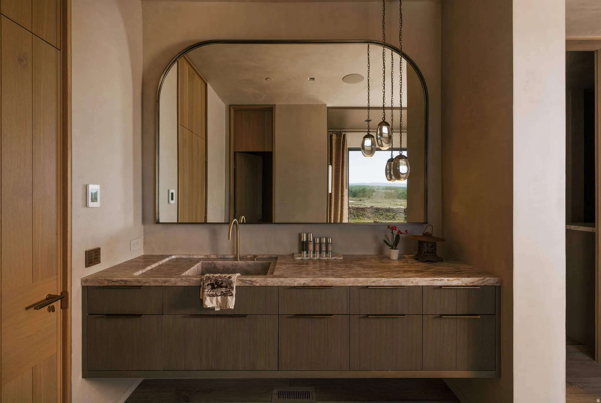 Floating vanity with an integrated basin and a substantial stone countertop
