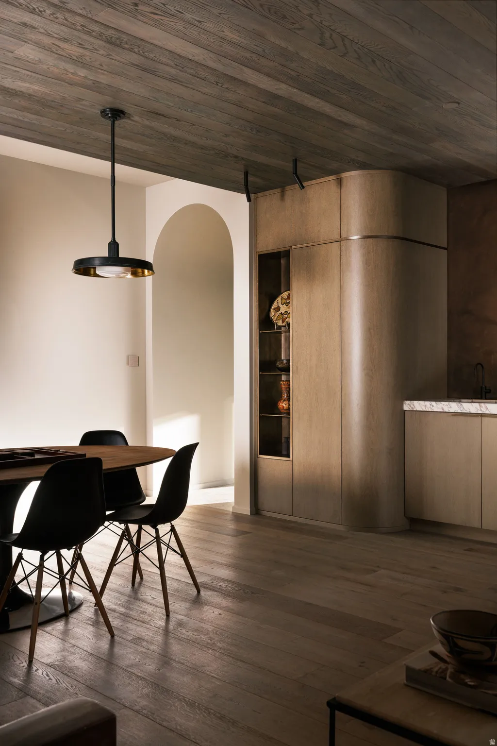 Spacious dining area featuring wood-finish flooring and a coordinating wood-paneled ceiling
