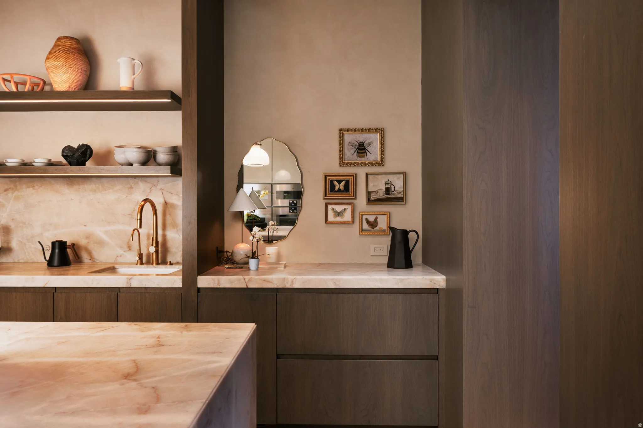 Kitchen area featuring warm-toned cabinetry and light-hued countertops