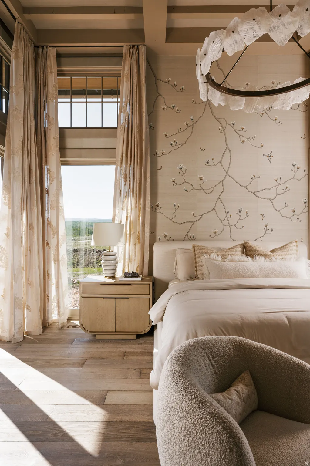 Hardwood flooring complements a decorative accent wall with floral-inspired design