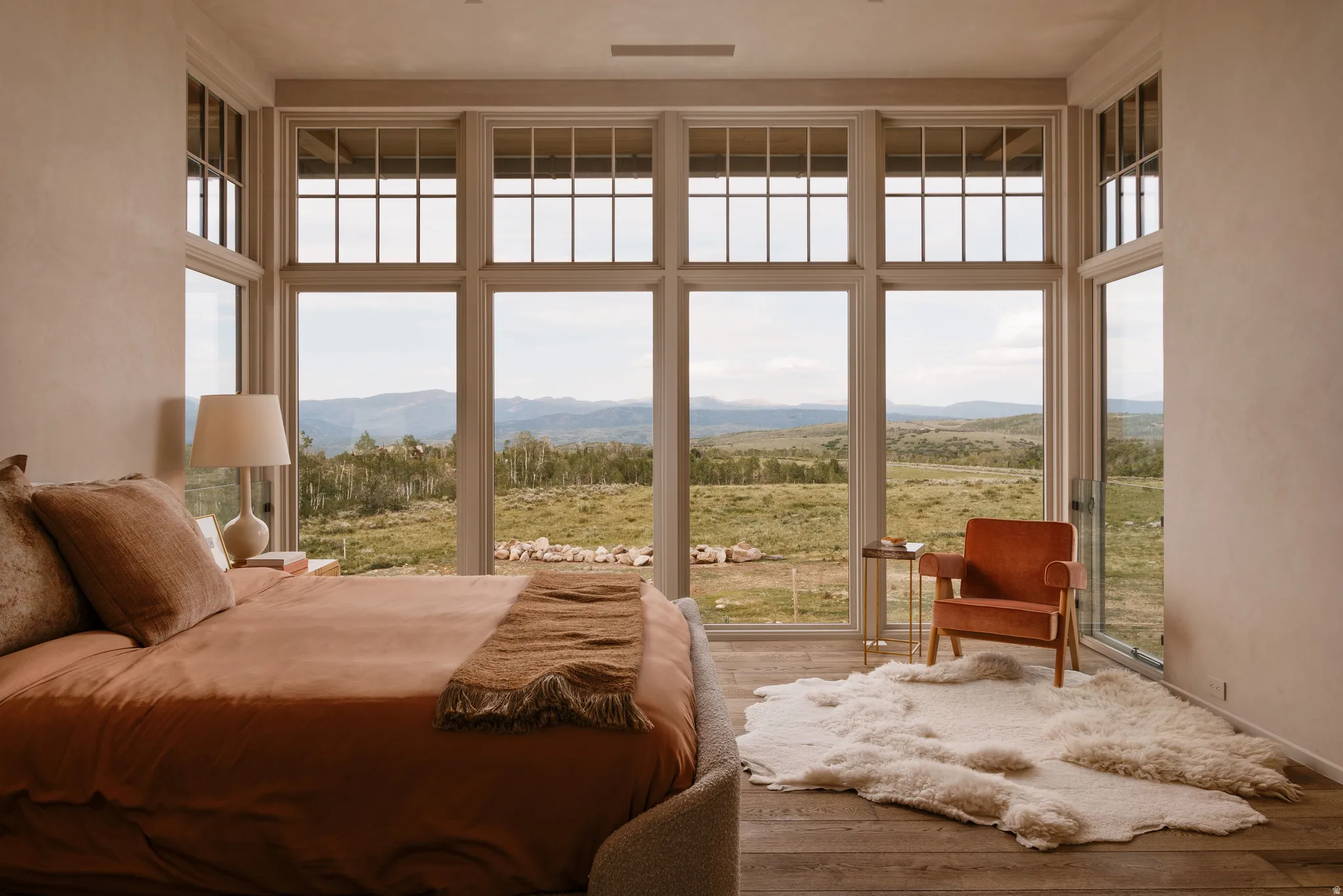 Expansive floor-to-ceiling windows featuring transoms overlooking a mountainous landscape