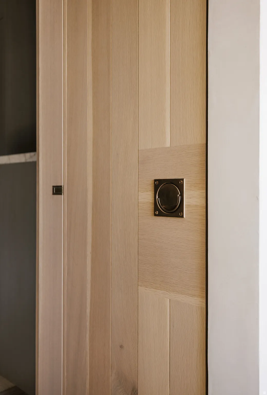 Light wood-finish door with recessed panel detailing
