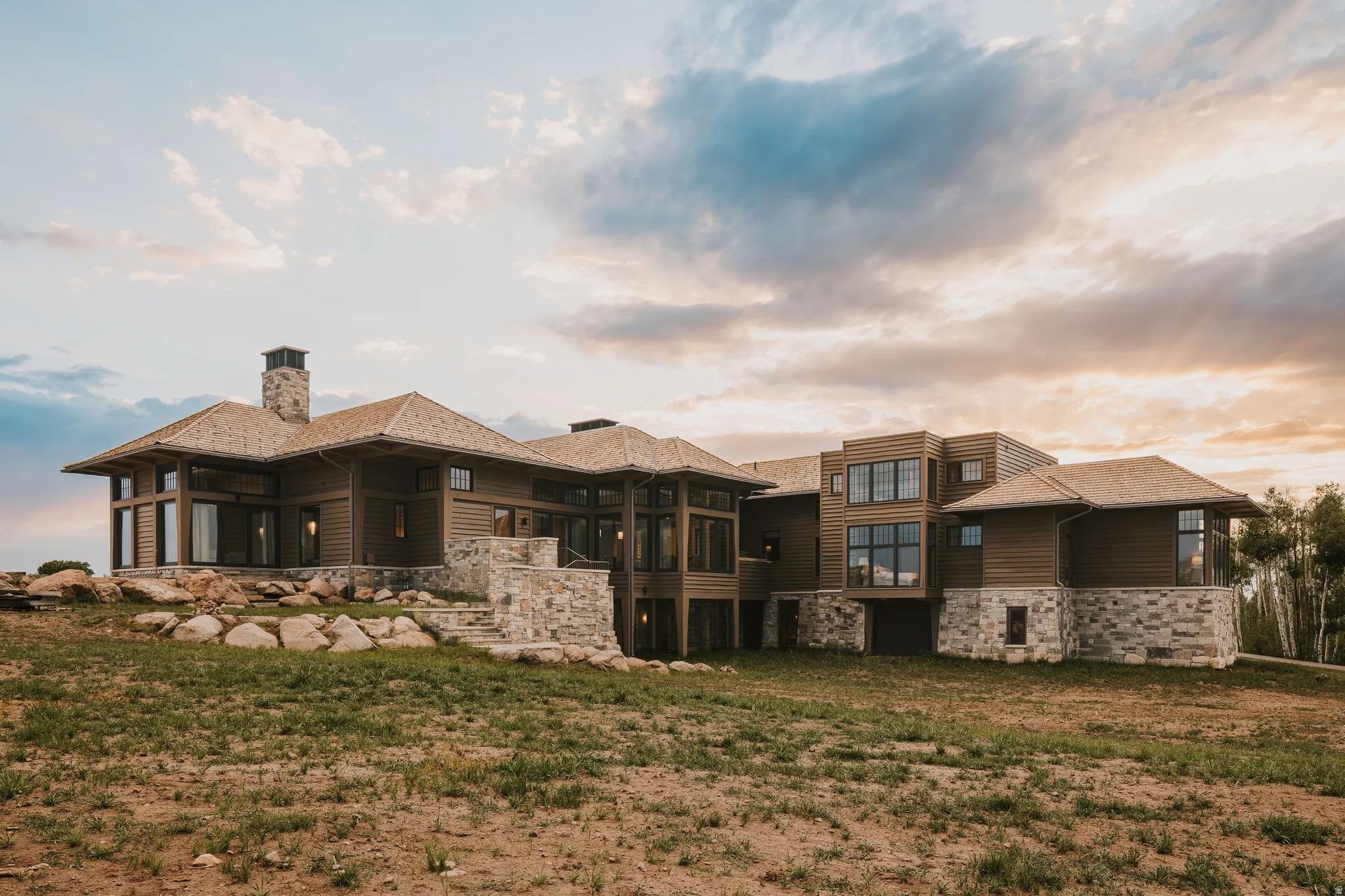 Contemporary multi-level residence featuring wood siding and stone accents