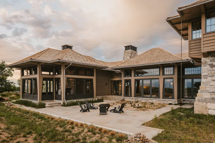 Expansive patio featuring flagstone paving and a built-in fire pit