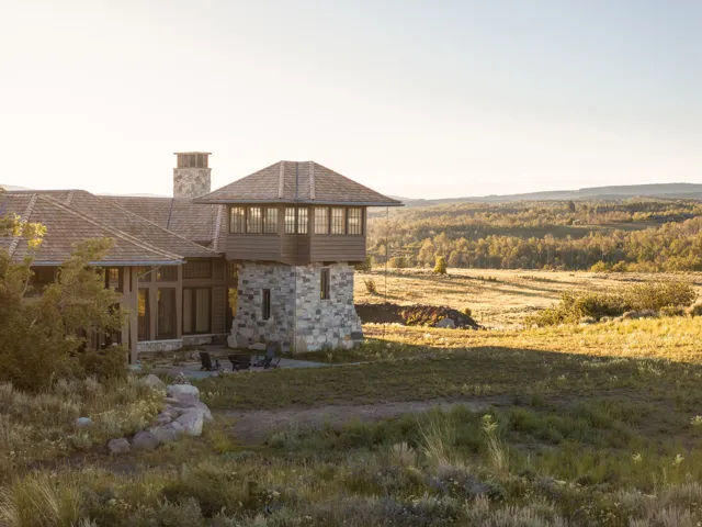 Stone and wood-sided architectural style featuring a multi-level design