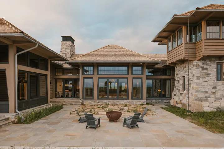 Expansive stone patio with a central fire pit feature