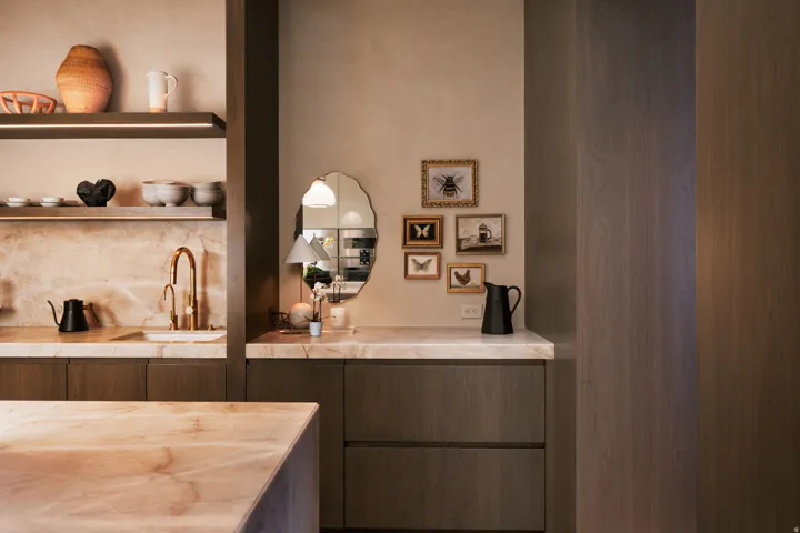 Kitchen area featuring warm-toned cabinetry and light-hued countertops