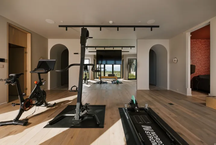 Dedicated fitness space featuring light wood-finish flooring