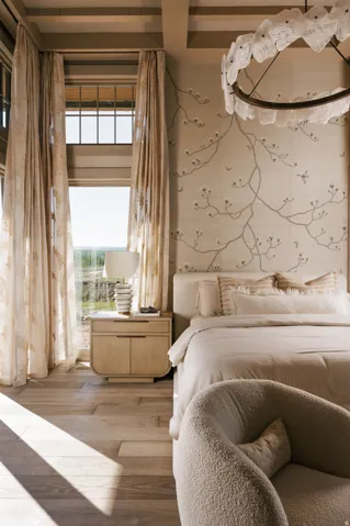 Hardwood flooring complements a decorative accent wall with floral-inspired design