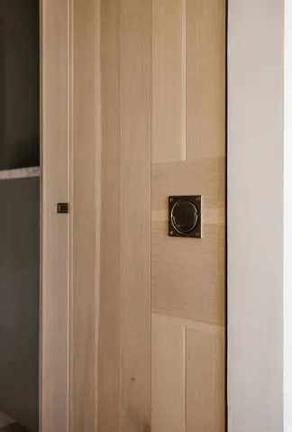 Light wood-finish door with recessed panel detailing