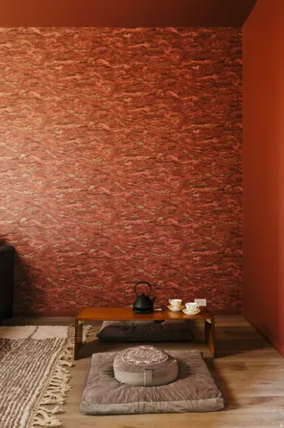 Accent wall with textured red finish, complemented by solid red painted walls and ceiling