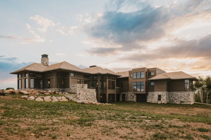 Contemporary multi-level residence featuring wood siding and stone accents