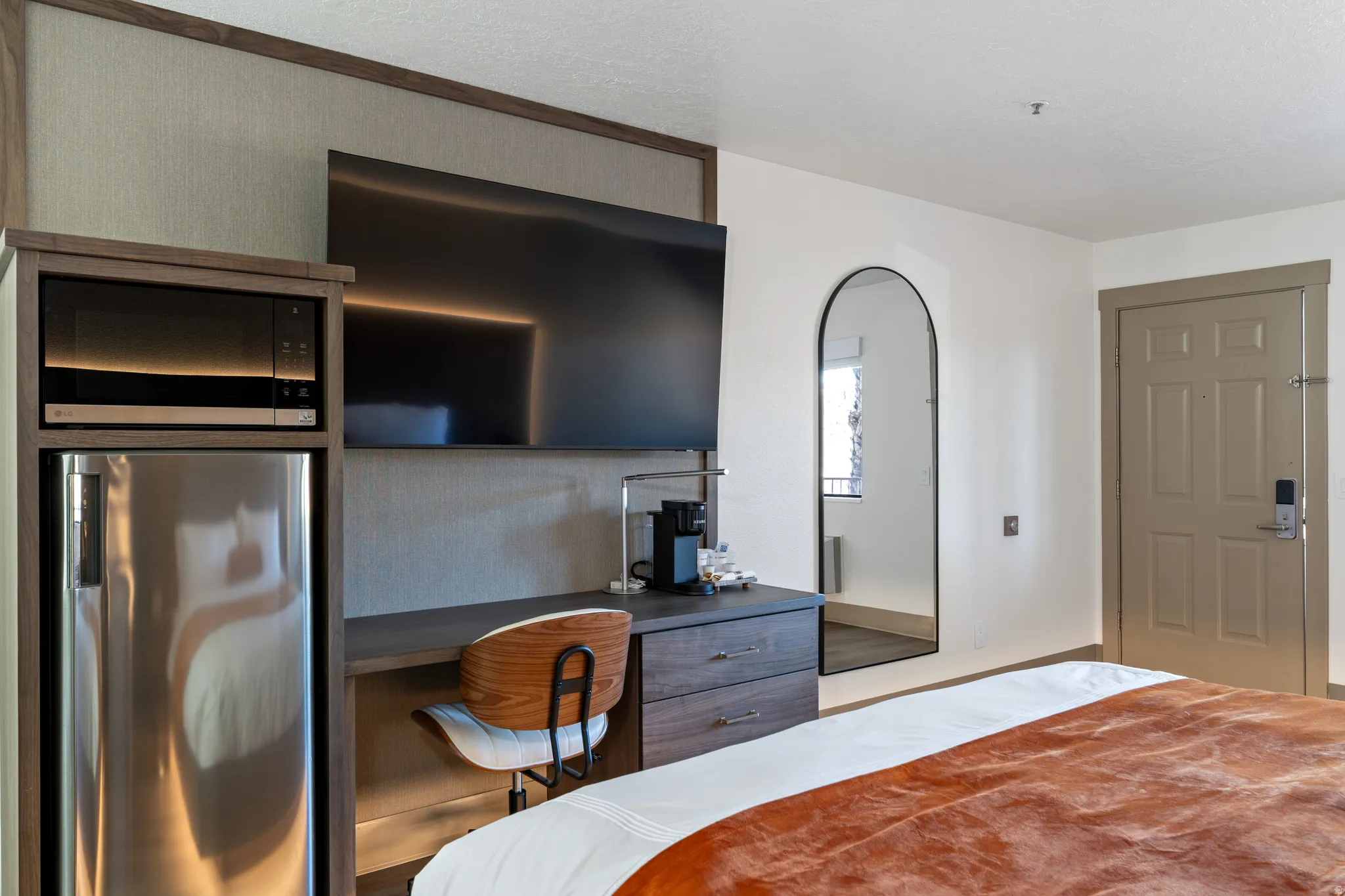 Integrated kitchenette area with microwave and stainless steel refrigerator