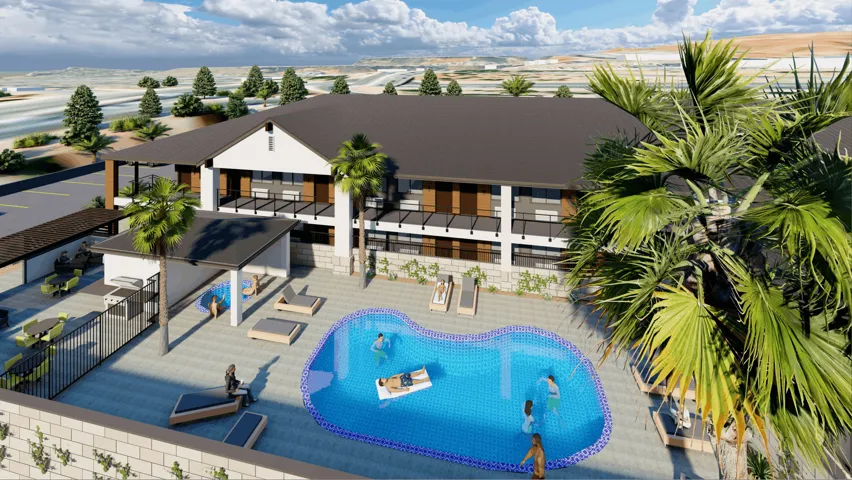Resort-style pool area featuring a freeform swimming pool with blue tile edging, expansive paver decking, and a shaded outdoor kitchen area