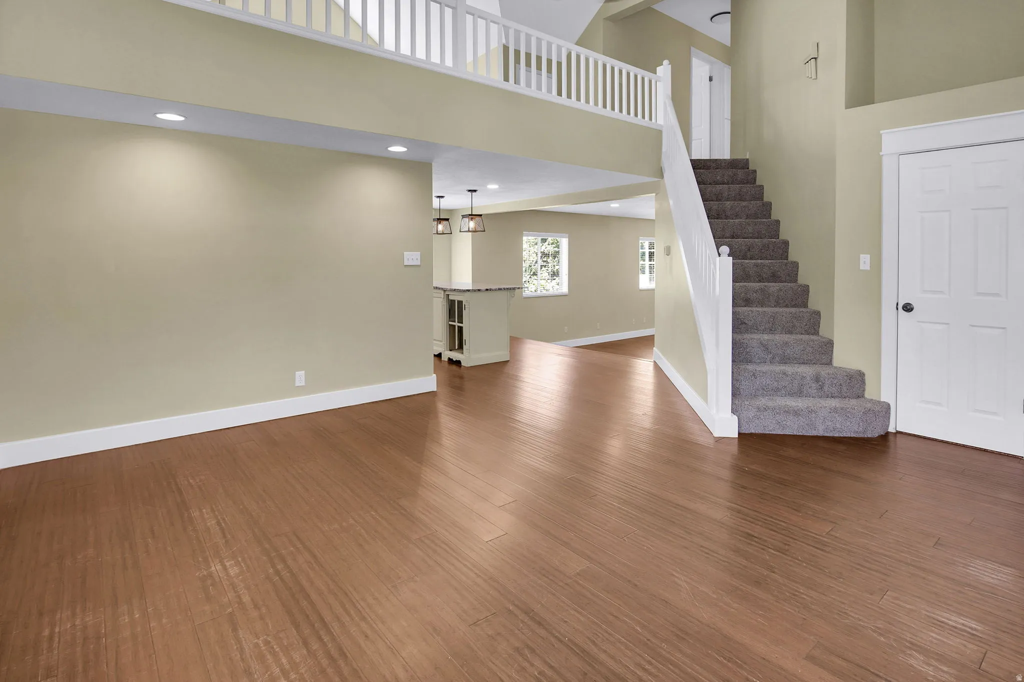 Expansive main living area featuring wood-finish flooring throughout the ground level
