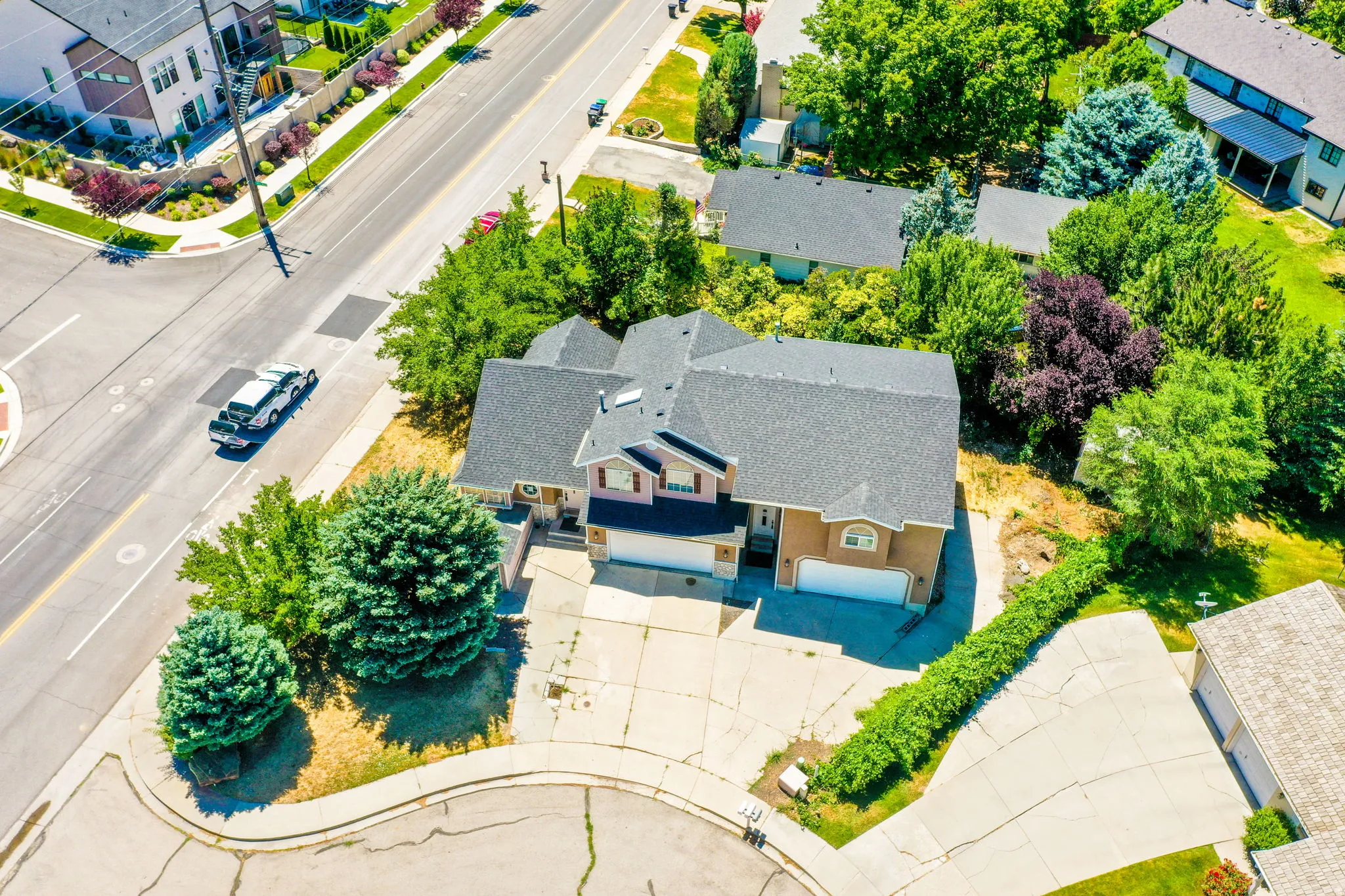 Two-story residence featuring a gray shingle roof and a two-car garage