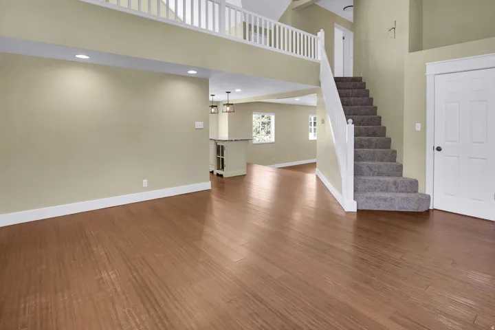 Expansive main living area featuring wood-finish flooring throughout the ground level