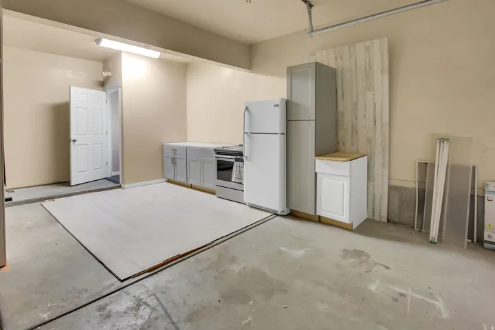 Utility space featuring a concrete floor, light-colored walls, and a fluorescent overhead light fixture
