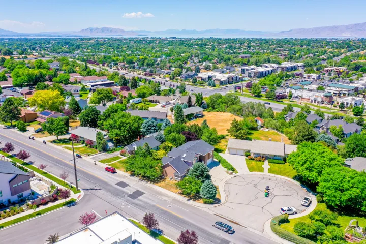 Expansive residential area featuring established homes, mature trees, and a distant mountain range