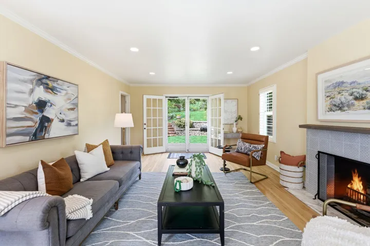 Living space featuring light wood-finish flooring, recessed lighting, and crown molding