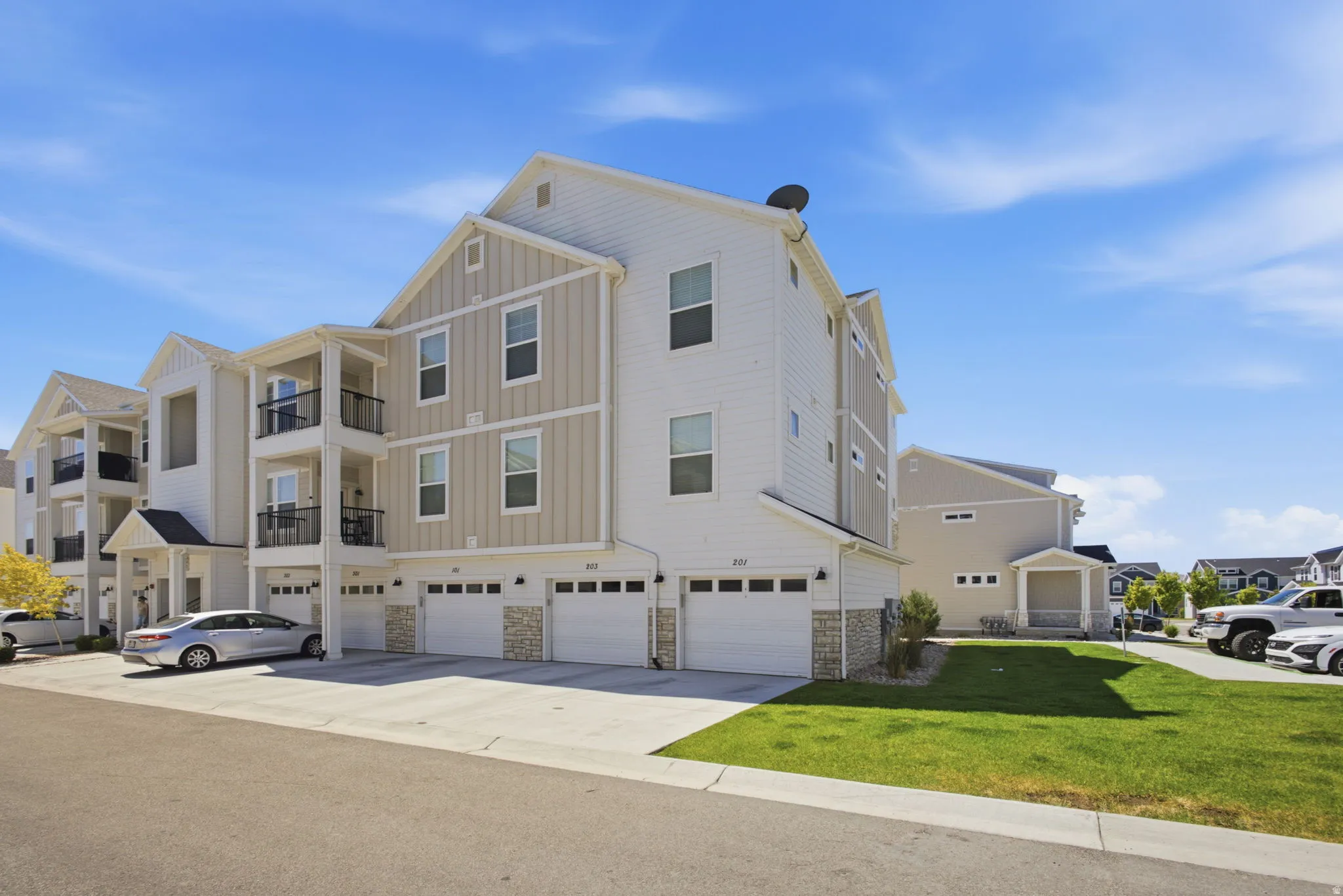 Contemporary multi-story exterior featuring white siding and vertical board and batten accents