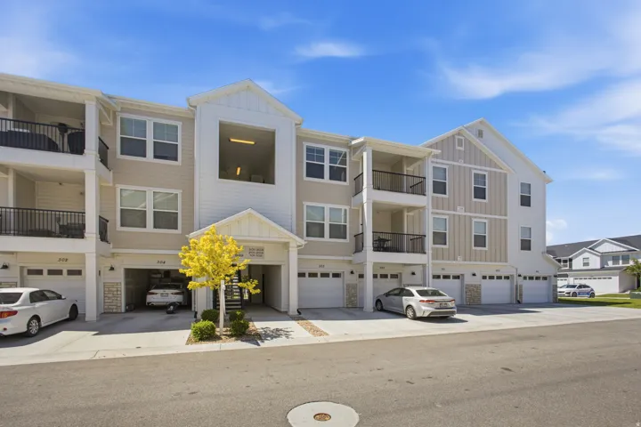 Modern multi-story building featuring light-colored siding and white trim accents