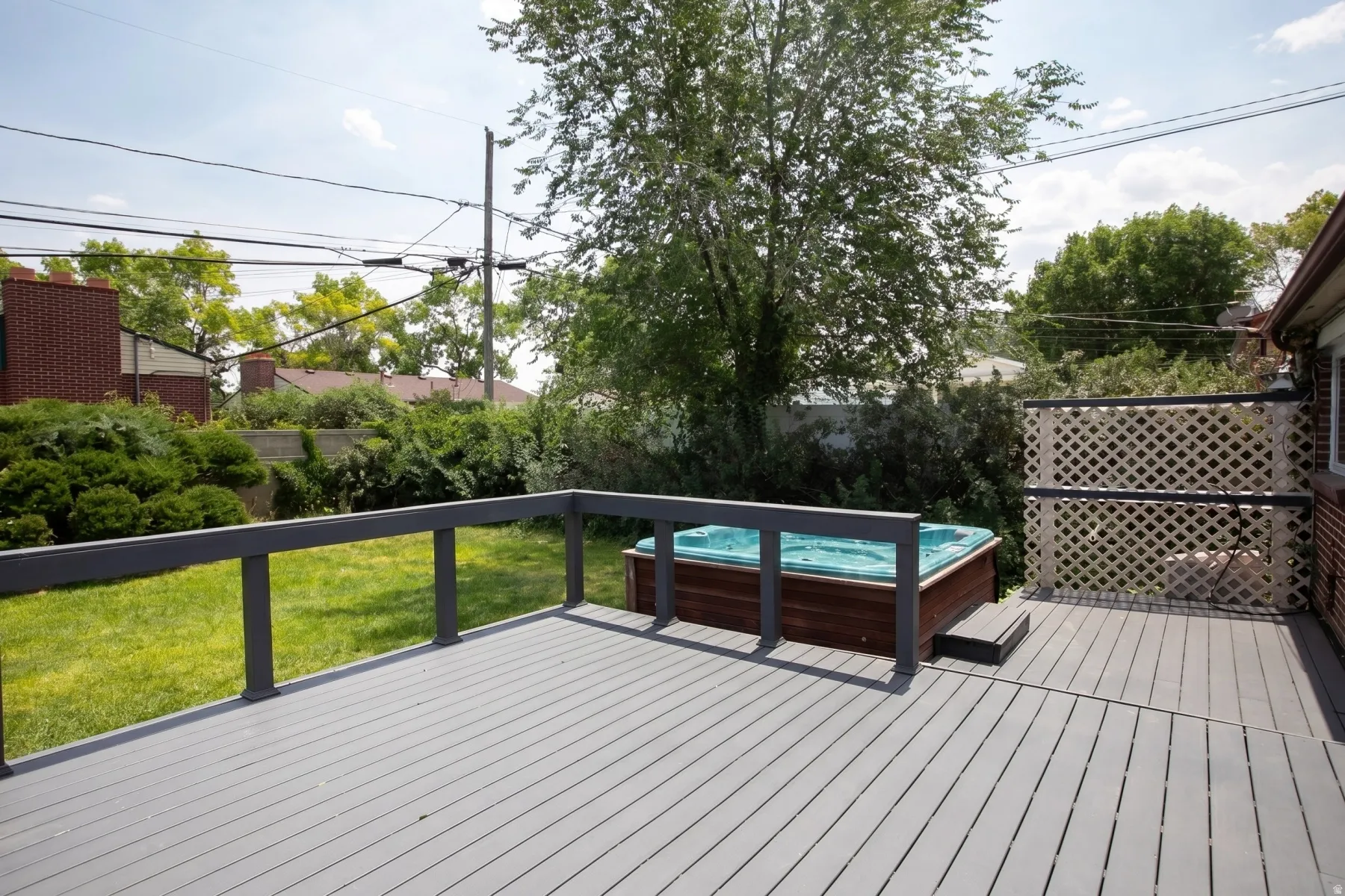 Expansive outdoor deck featuring composite decking and dark gray railings