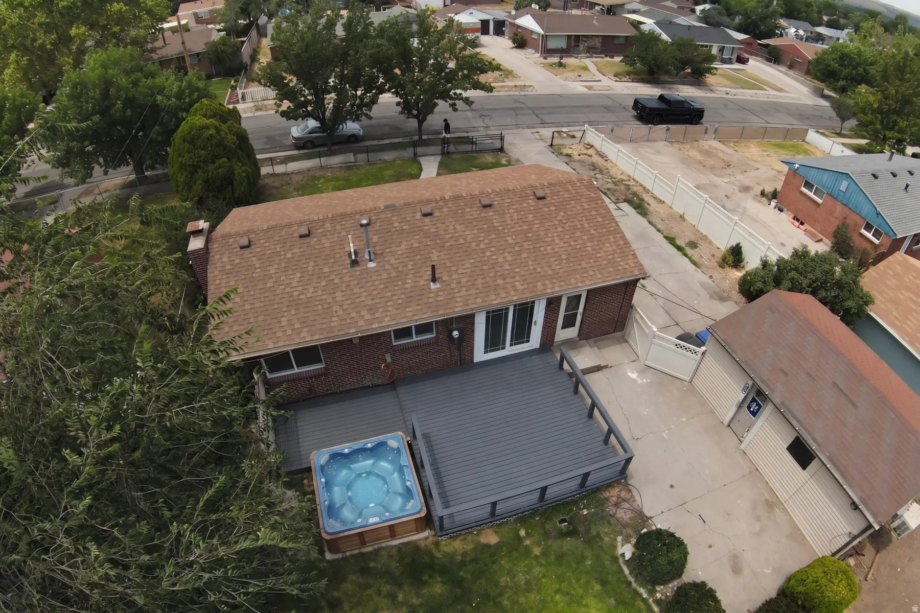 Red brick exterior with a brown shingle roof