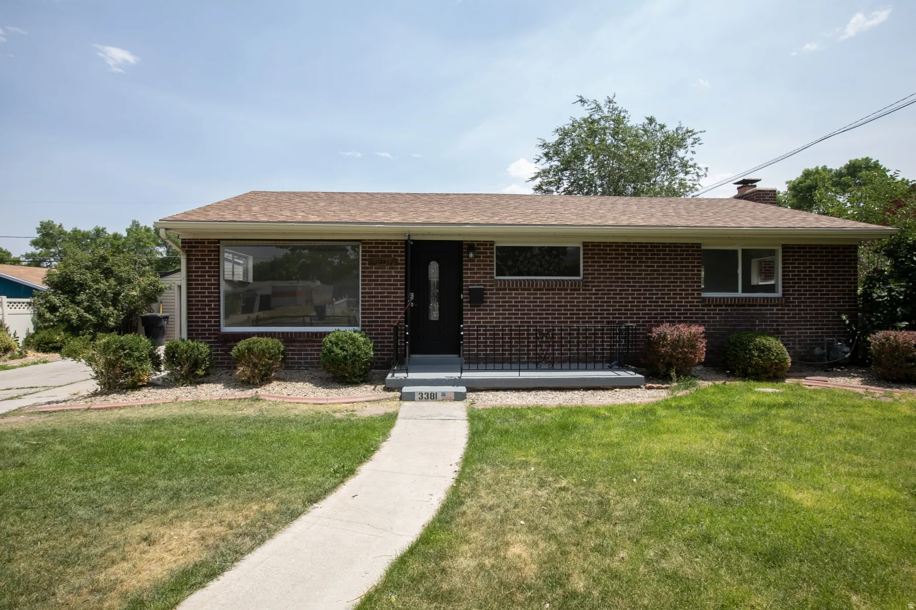 Brick exterior with a light brown shingle roof