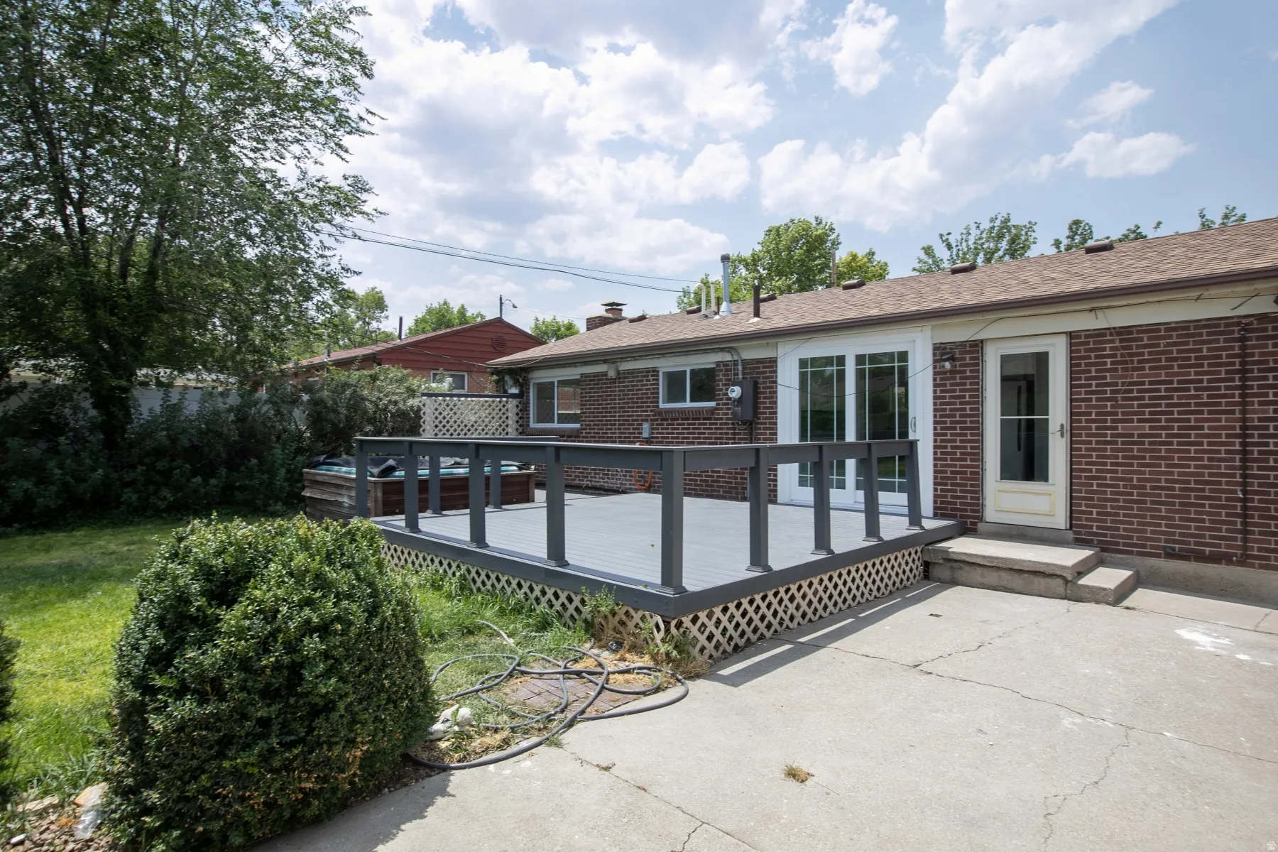 Expansive rear deck featuring a gray finish and dark railings
