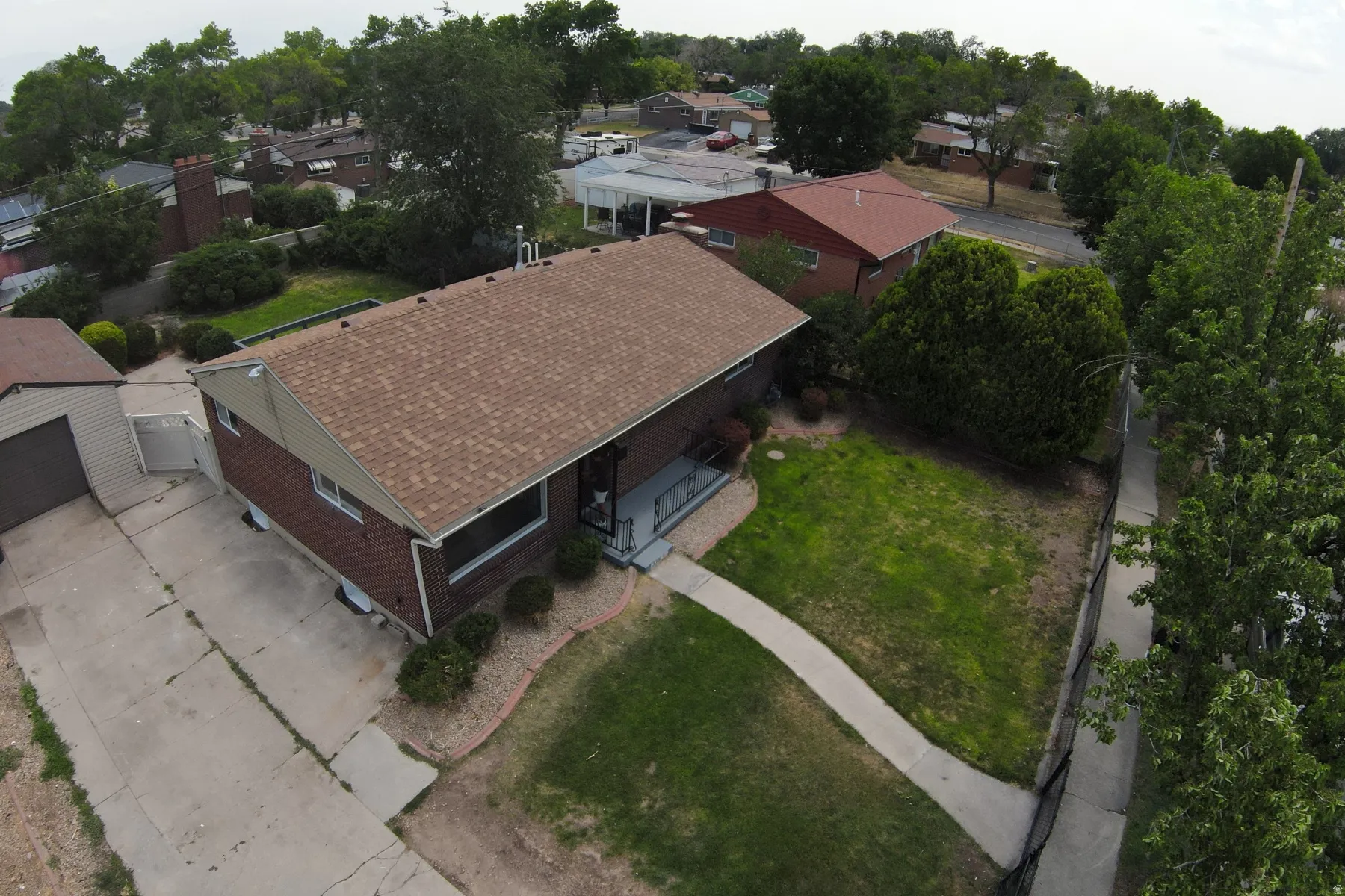 Brick exterior with a brown shingle roof