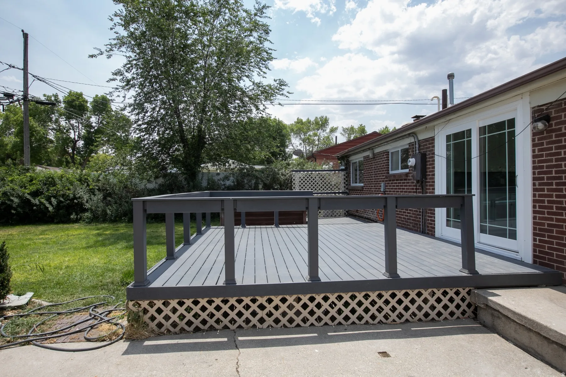 Spacious exterior deck with gray composite decking and matching railings