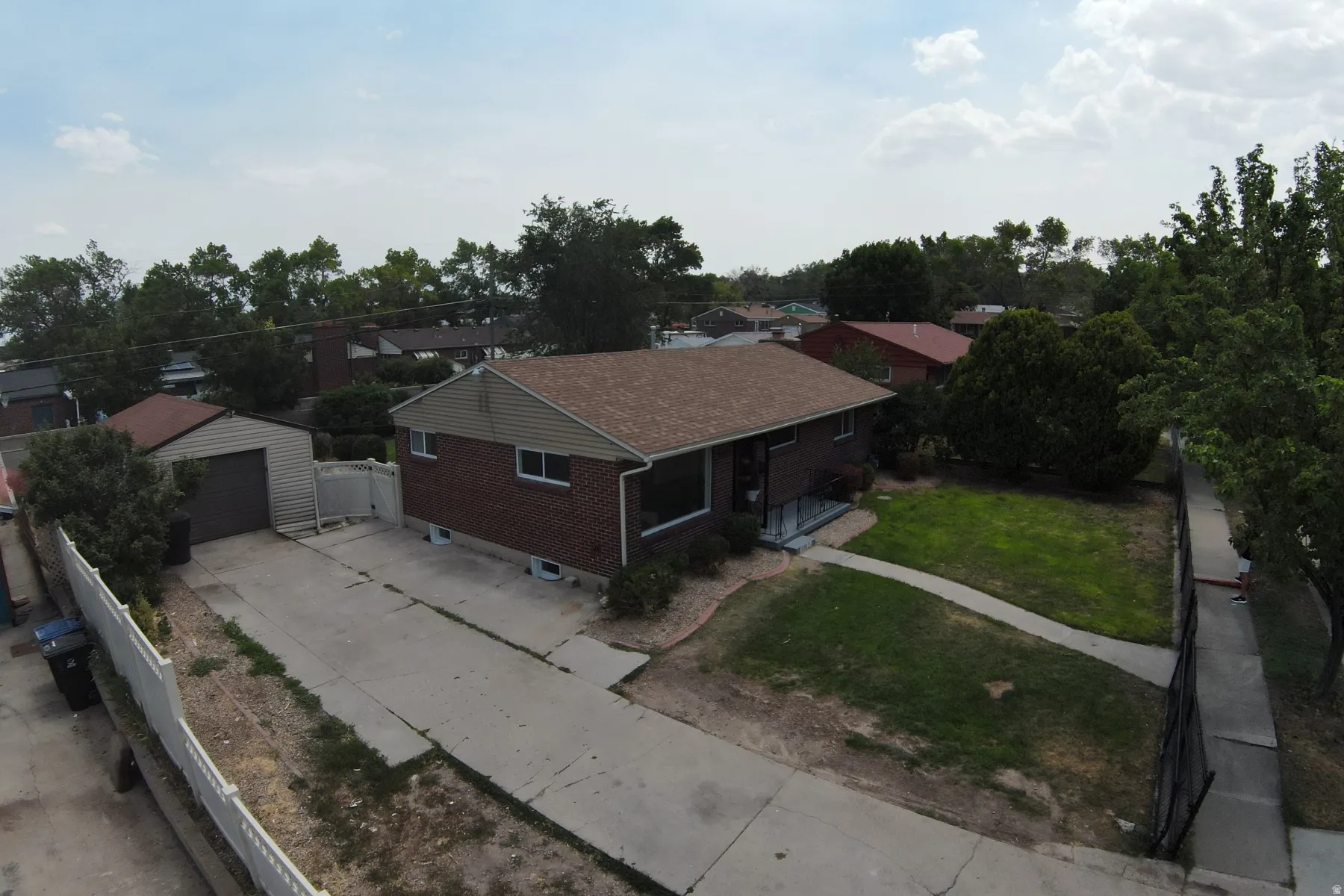 Brick and siding exterior with a brown shingle roof
