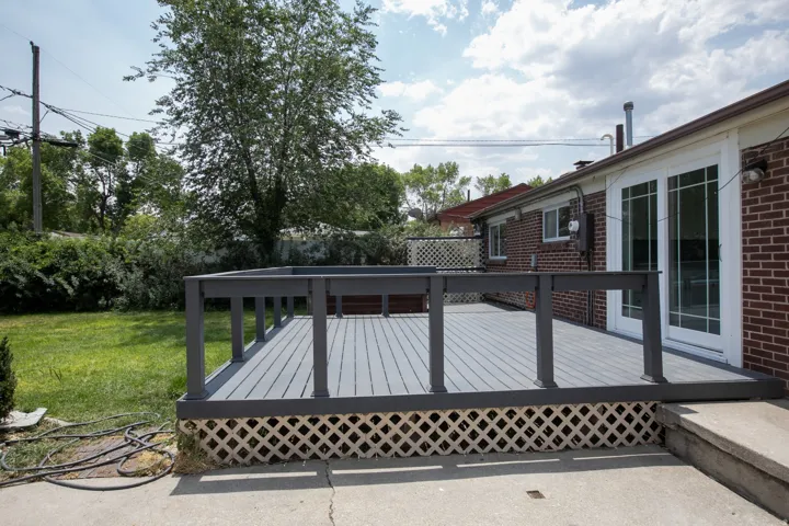 Spacious exterior deck with gray composite decking and matching railings