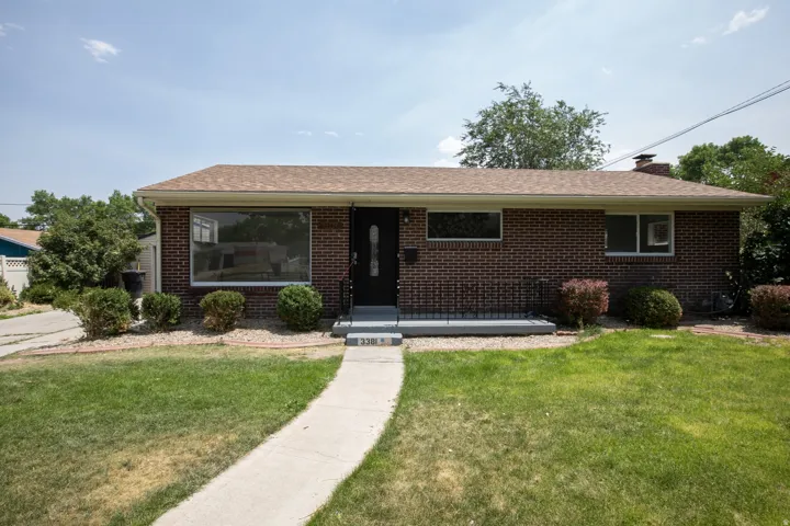 Brick exterior with a light brown shingle roof