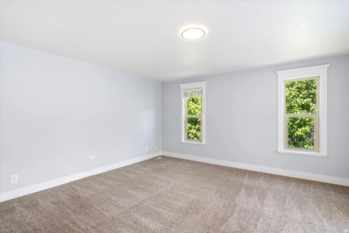 Neutral gray walls complement the new carpet flooring