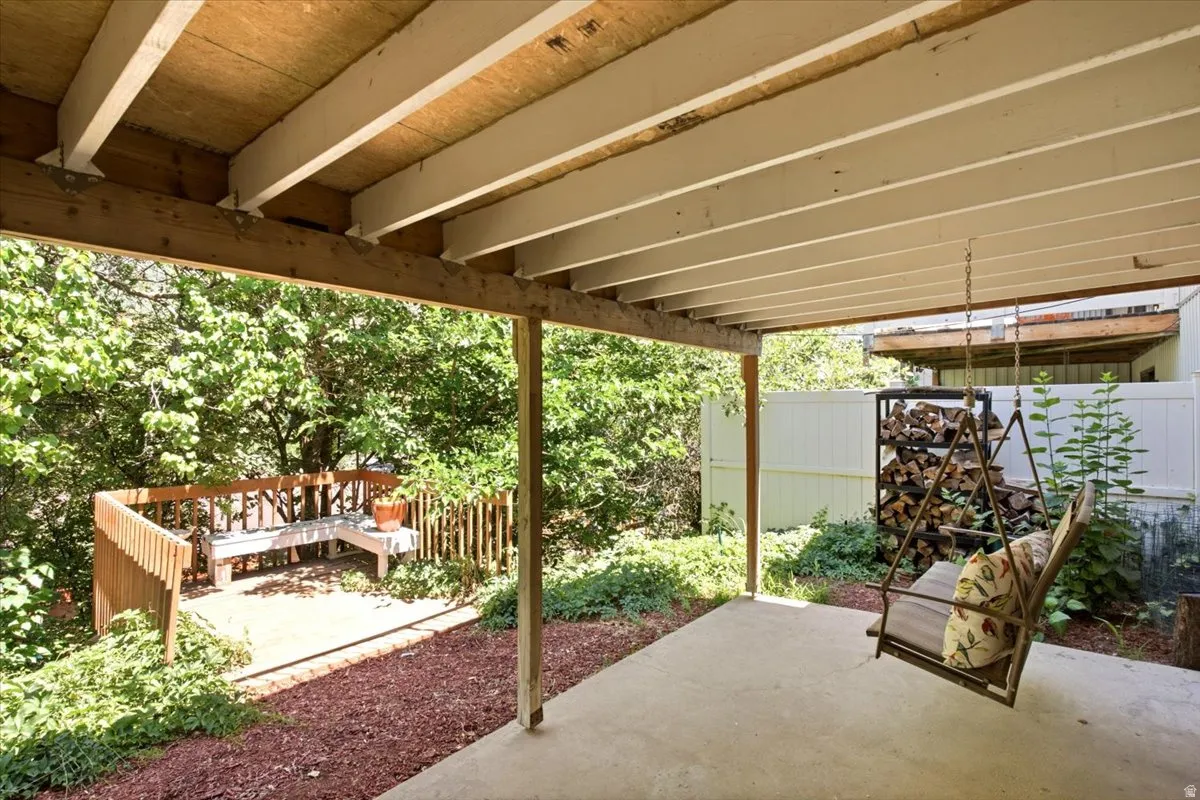 Covered patio featuring a concrete surface and exposed wooden beams