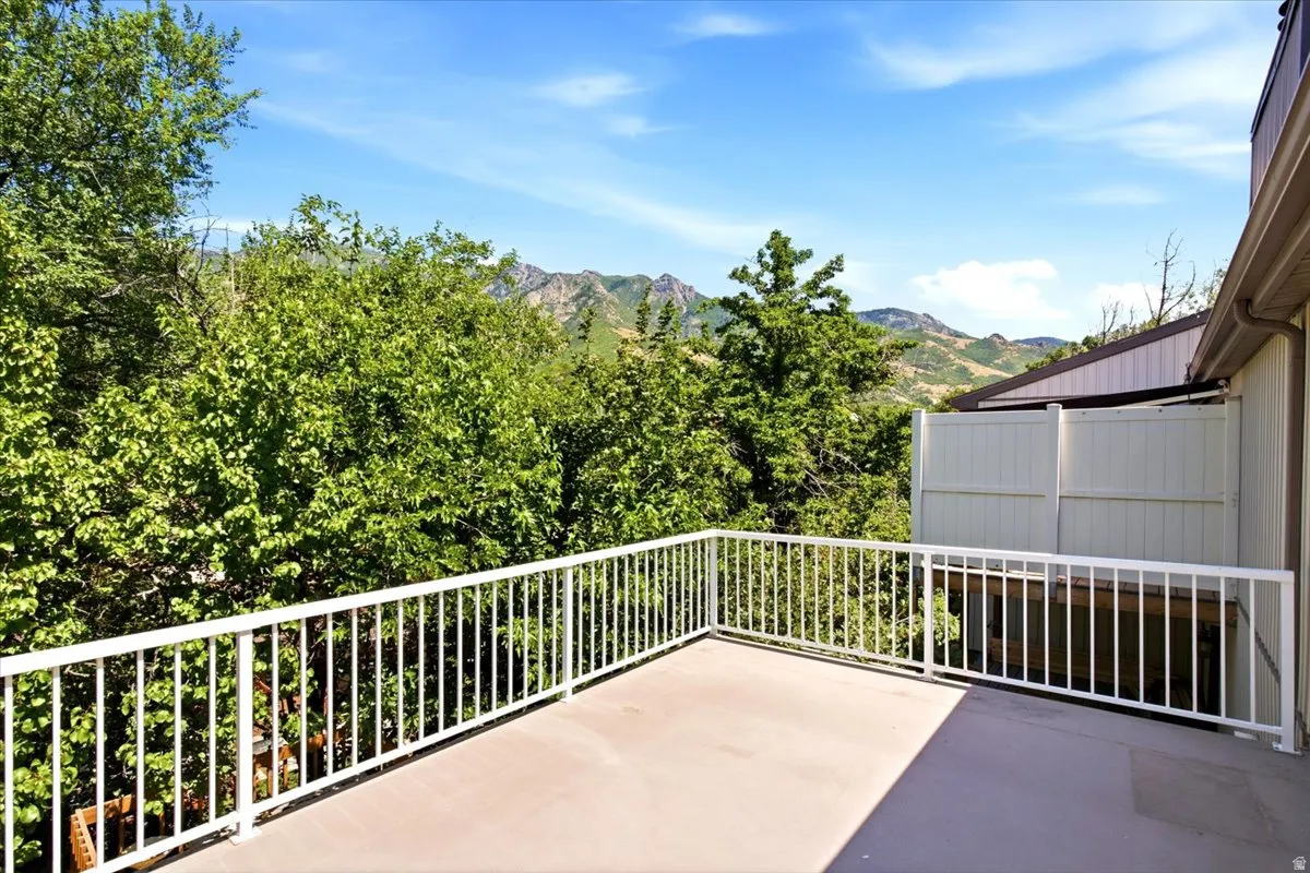 Outdoor deck with a concrete surface and white railing