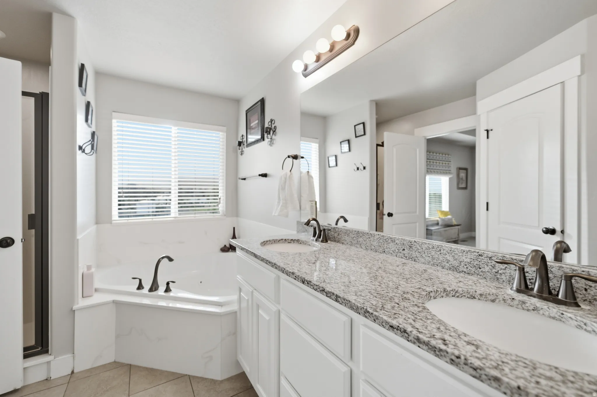 Dual vanity with a stone countertop and undermount sinks