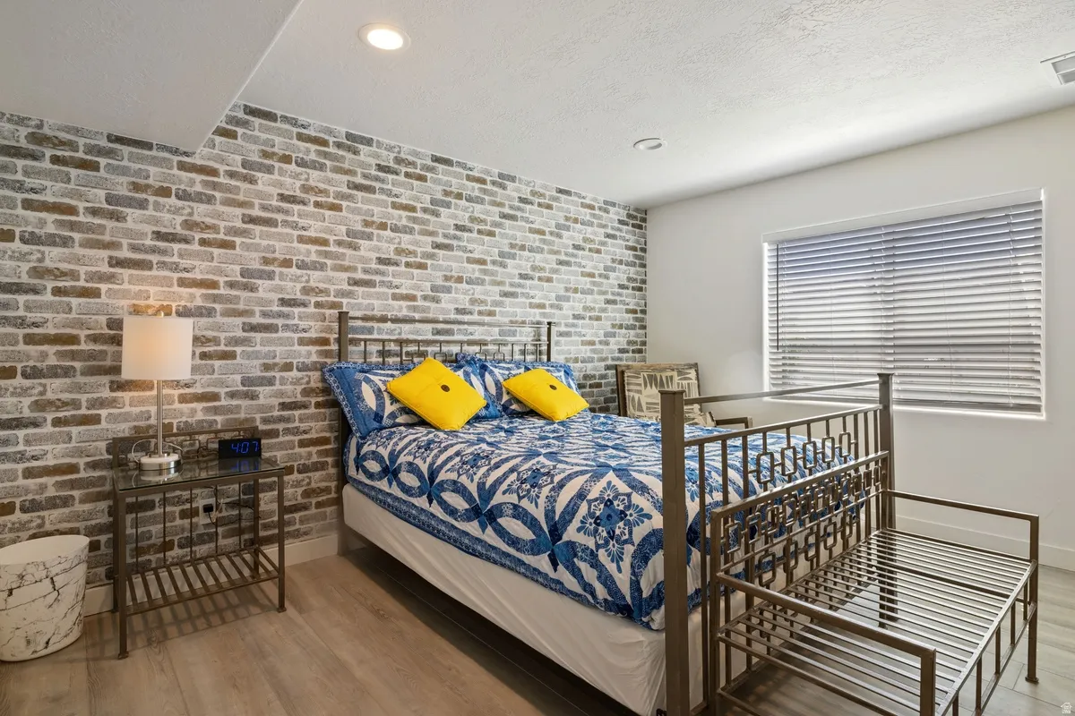 Accent brick wall featuring a neutral color palette