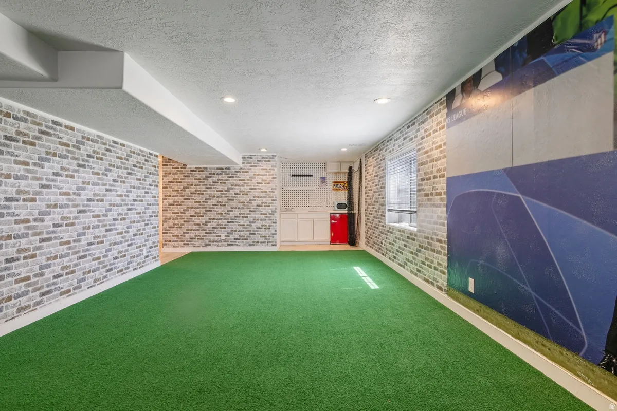 Indoor green turf flooring with recessed lighting