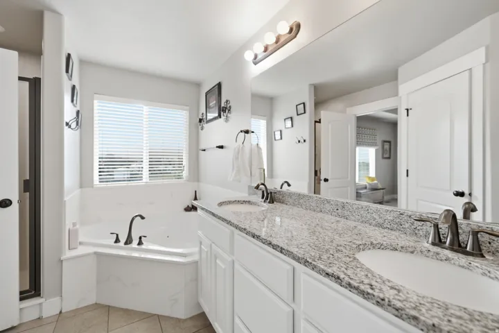 Dual vanity with a stone countertop and undermount sinks
