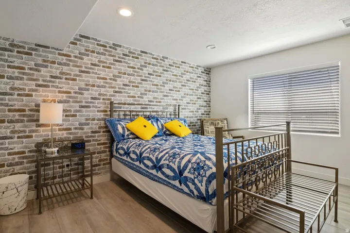 Accent brick wall featuring a neutral color palette
