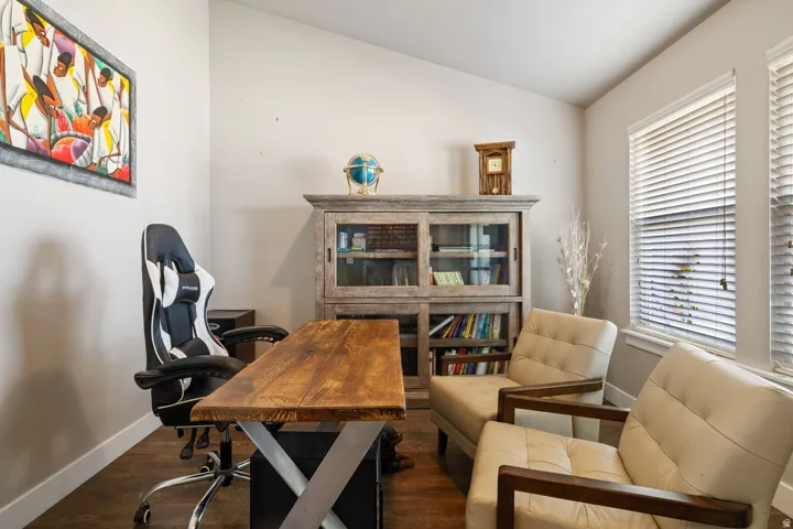 Warm wood-finish flooring complements the neutral wall tones