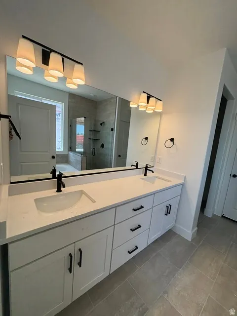 PRIMARY SUITE BATHROOM W/ DOUBLE SINKS...WHITE CABINETS...AND WHITE QUARTZ COUNTERTOPS!