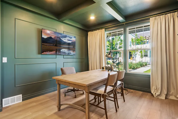 Refined interior space featuring wainscoting paneling, wood-finish flooring, and a coffered ceiling with recessed lighting