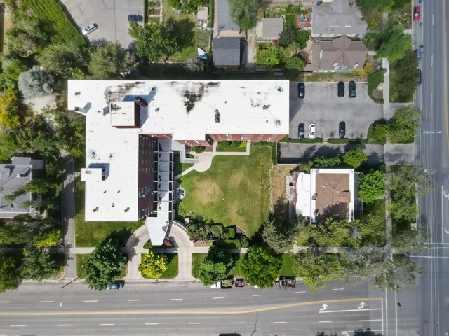 Multi-story brick building with a white roof
