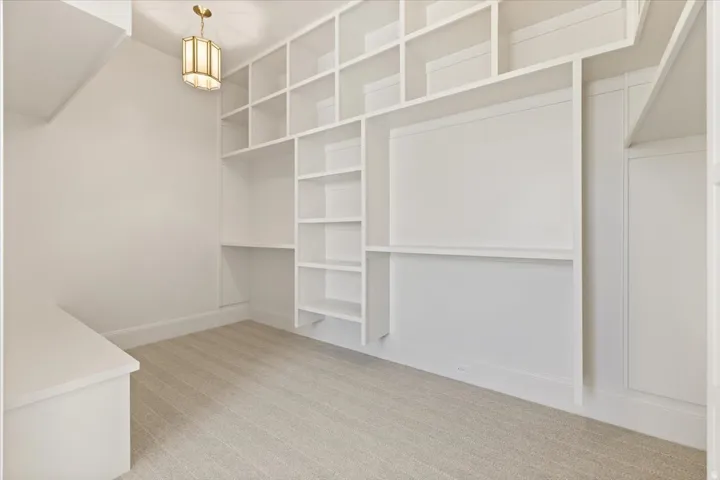 Built-in shelving and desk areas featuring a clean white finish