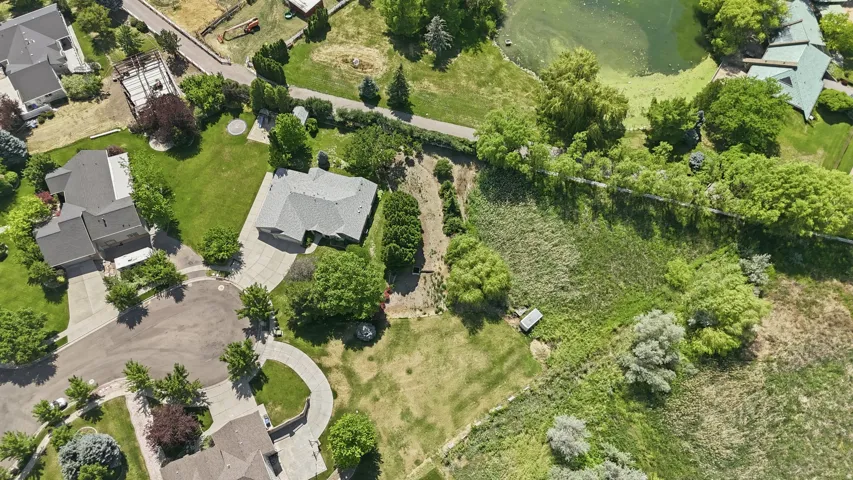 Residential property situated on a cul-de-sac with surrounding green space, mature trees, a private driveway, and a spacious lot